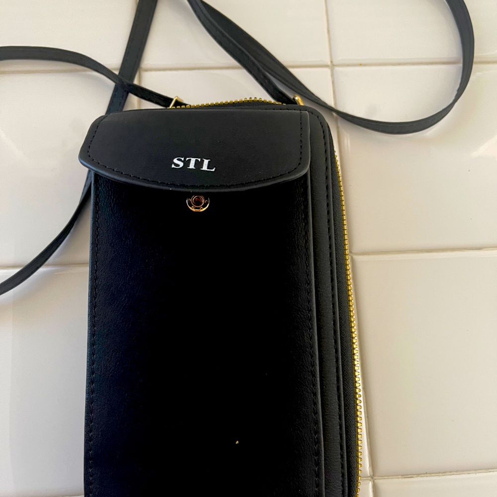 STL black zipper wallet with over the shoulder strap. Room for cards and cash.